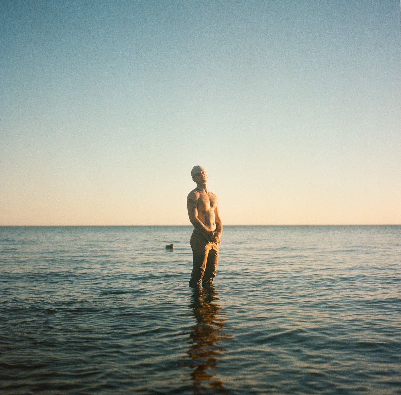 Martin standing in open water at sunset